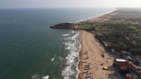 aerial drone shot of seashore temple surrounded by boats and buildings