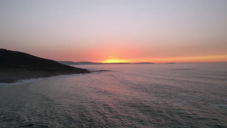 flying back to the beach with the sunset over the horizon