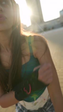 teenage girl roller skating in the city at sunset