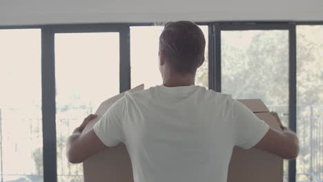 young man walking in empty apartment