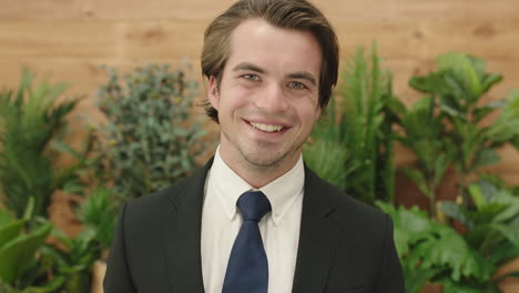 attractive young business man portrait of sales person wearing suit laughing cheerful enjoying successful lifestyle