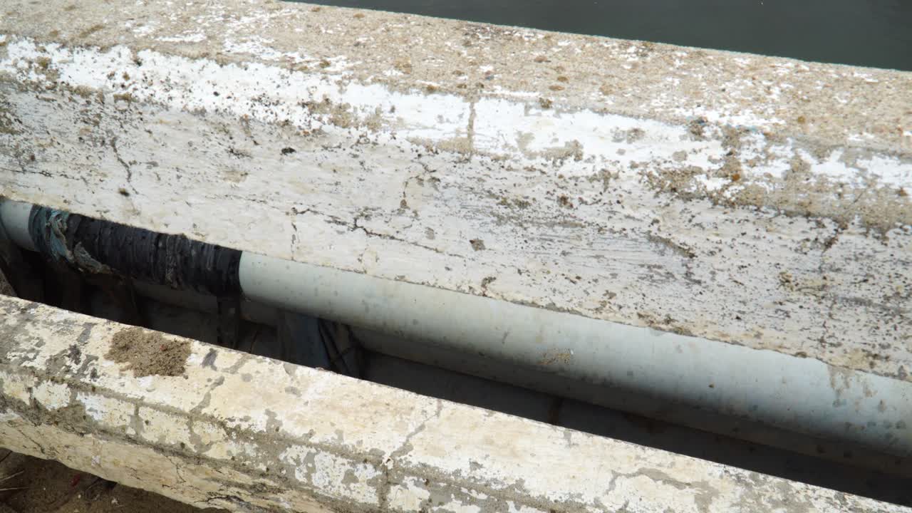 Trash Pollution On Riverbank At Son Hai In Vietnam. Tilt Up View From Bridge