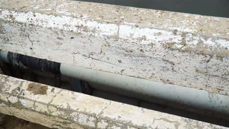 trash pollution on riverbank at son hai in vietnam. tilt up view from bridge