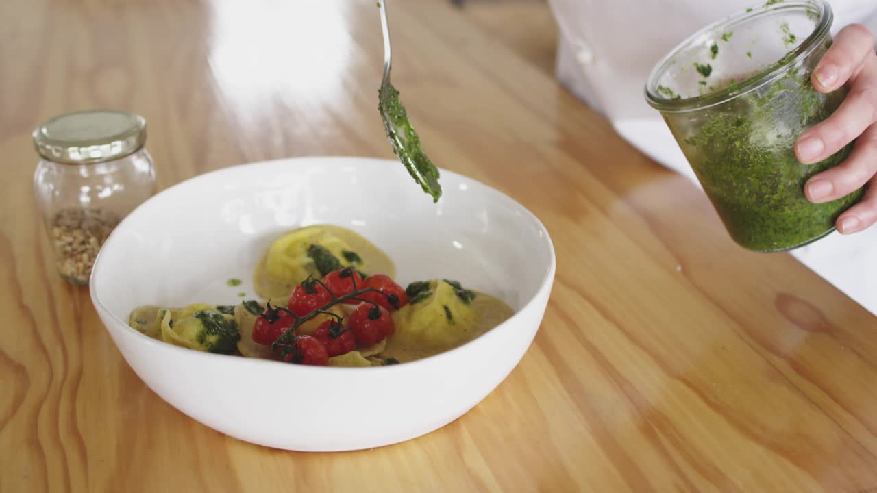Woman reaching for jar, making breakfast adding seed to pancake, pink overlay showing food motion