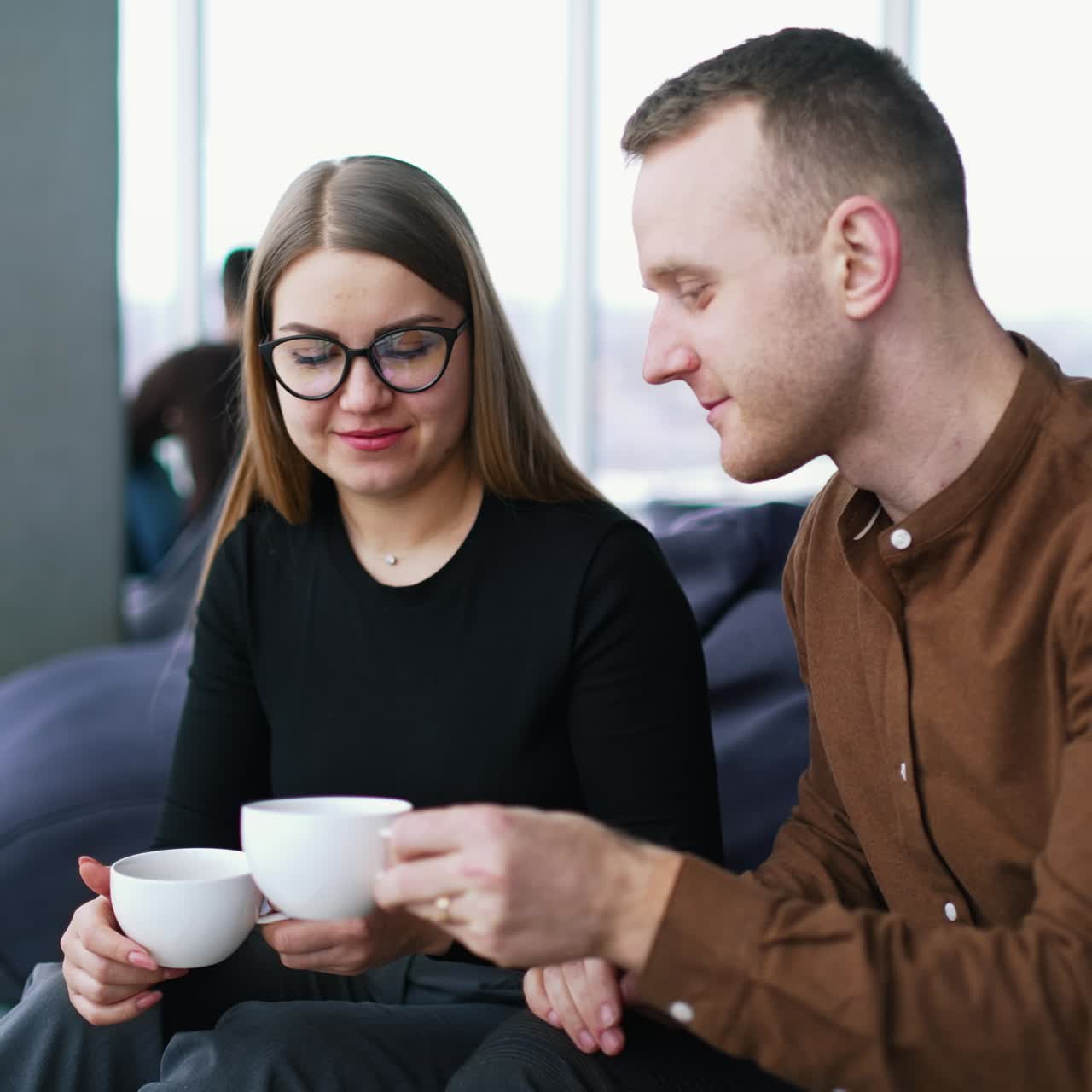 Business meeting of two professionals. Handsome businessman and beautiful businesswoman using laptop together in cafe