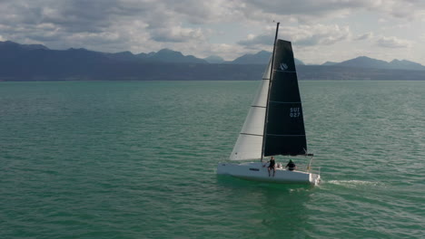 sailing on a lake with mountains in the background