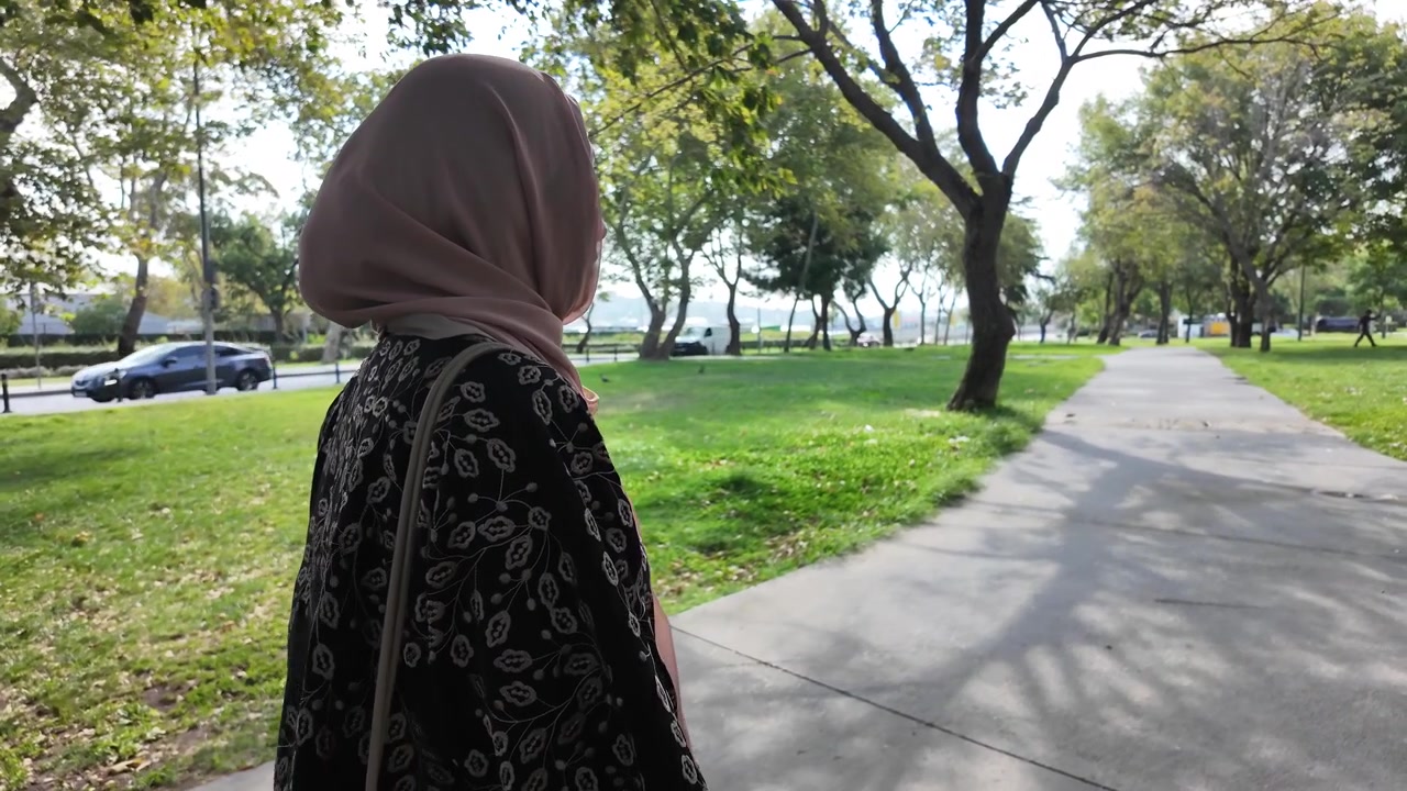 Young Woman Wearing Hijab Standing in a Sunny Park