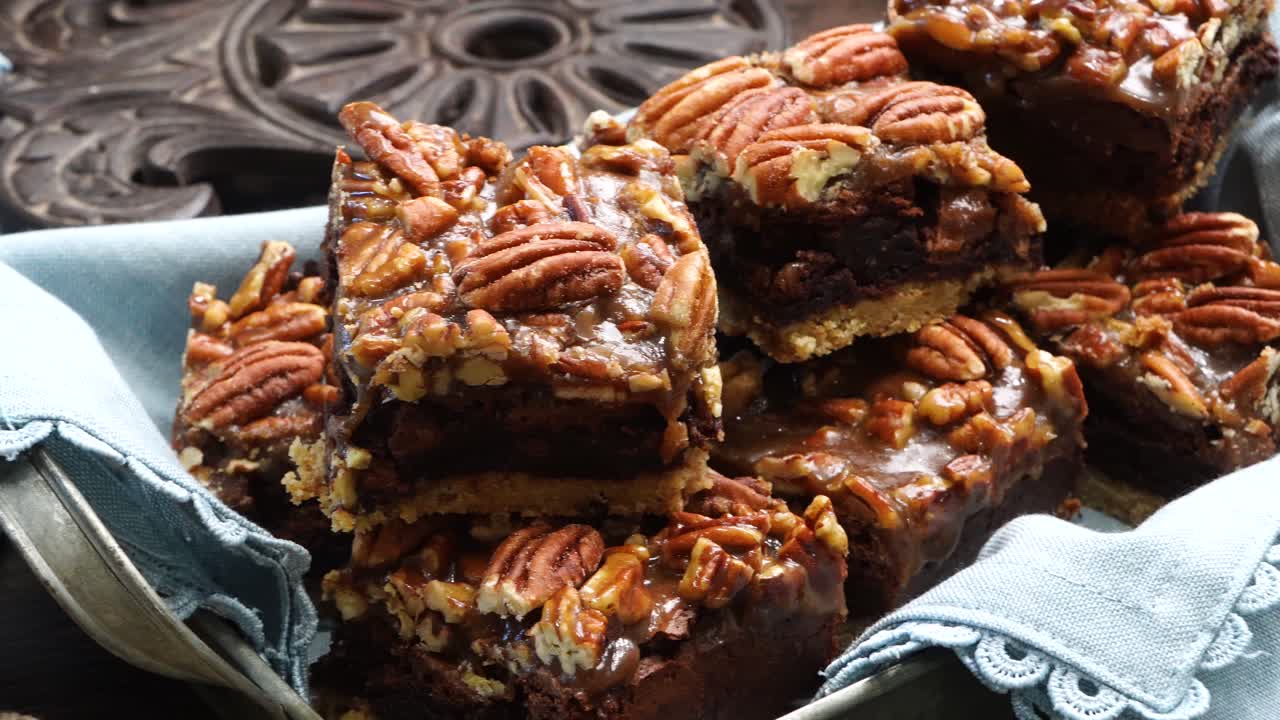 Baking delicious caramel pecan brownies. Panning across the baking pan with caramel pecan brownies. Freshly baked gooey chocolate brownies with sweet caramel and nutty pecans.