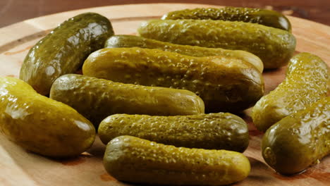 pickled cucumbers on wooden board