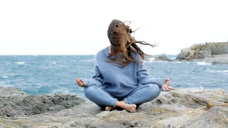 angry woman trying to practice yoga in a windy day