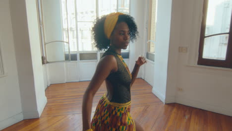 attractive african-american woman dancing tango and posing on camera in studio