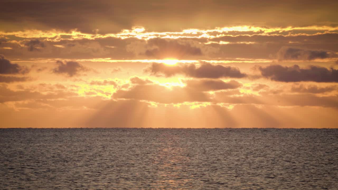 beautiful orange ocean sunrise with clouds and water
