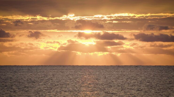beautiful orange ocean sunrise with clouds and water