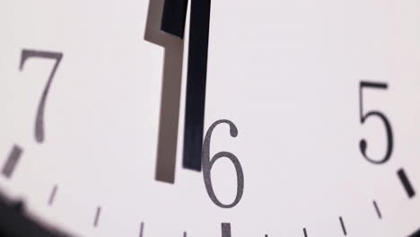 close white wall analog ticking clock shows the second and minute hands, midnight video