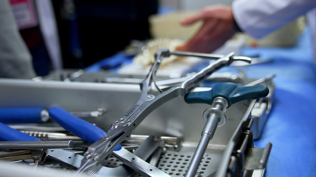 Wide range of metal neurosurgical instruments in the box. Close up. Demonstration of tools application at blurred backdrop. Neurosurgery training.