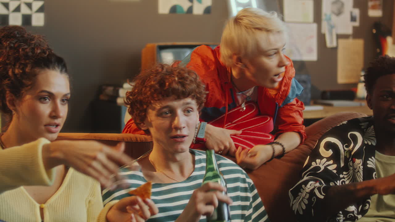 Friends Drinking Beer and Eating Snacks as Watching Sports Match at Home