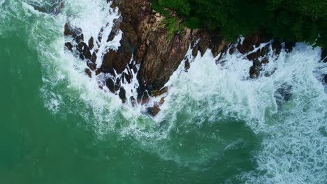 aerial view drone camera top down of seashore rocks in ocean beautiful sea surface amazing sea waves crashing on rocks seascape in phuket island thailand aerial view drone 4k high quality footage