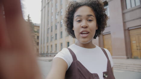 teenage girl taking a selfie in the city
