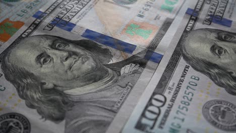 one hundred dollar bills laid out on the table. close-up