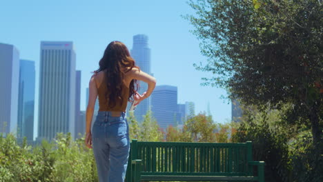 unrecognizable girl walking park to make photo cityscape. girl enjoy vacation.