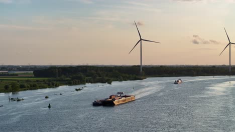 on a wide calm river cargo vessels sail onwards