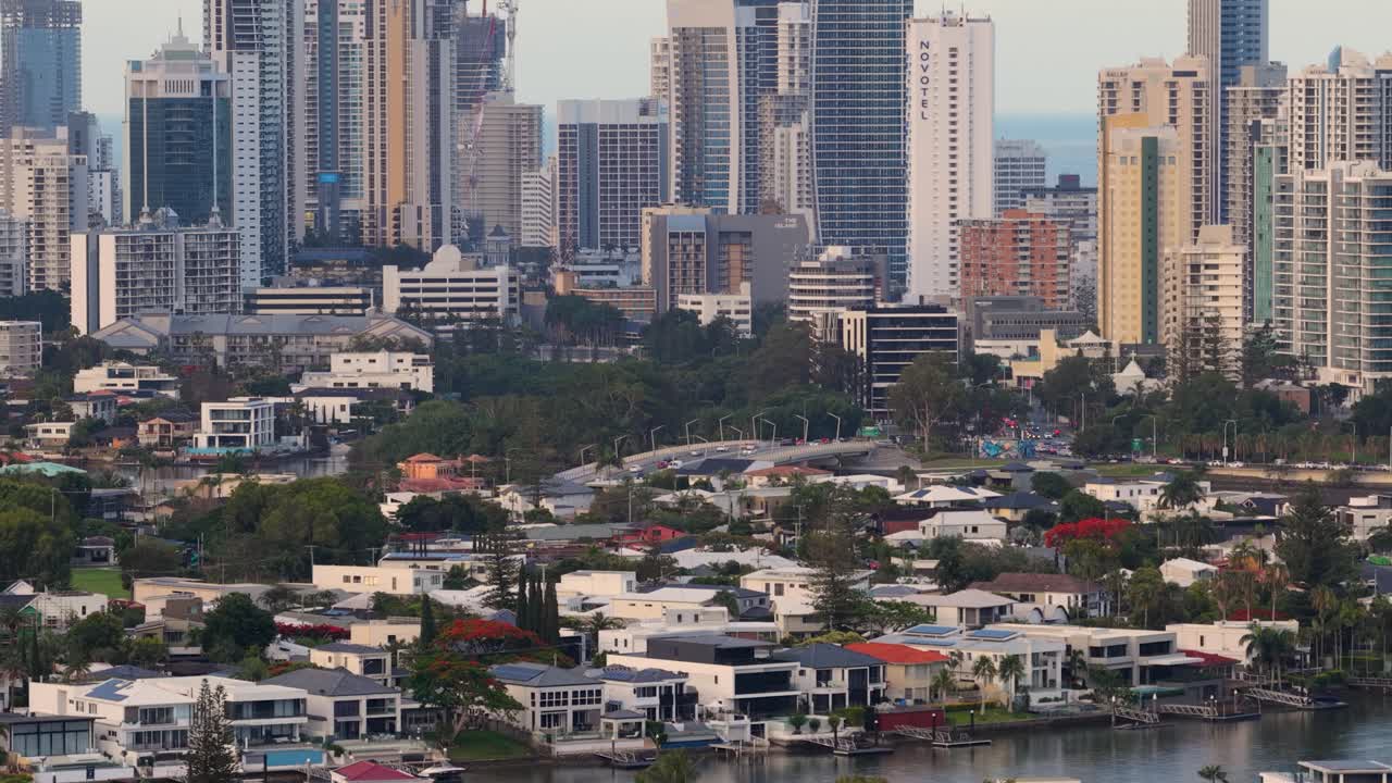 Wide shot pans across modern skyscrapers and residential areas under soft daylight, steady camera movement