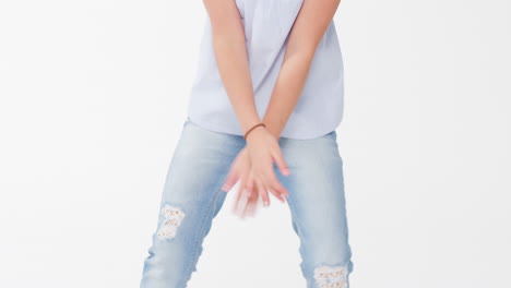 young girl dancing against white background in slow motion