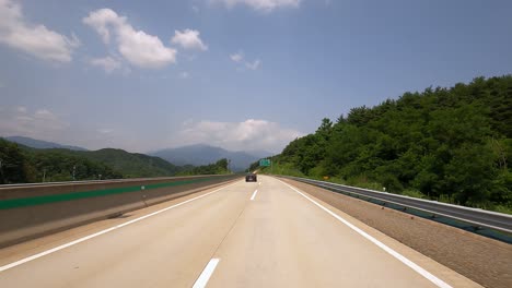 traveling on long asphalt highway with fast car passing by