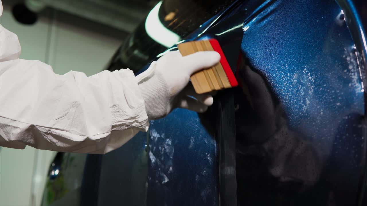 Applying Protective Film to Car Body