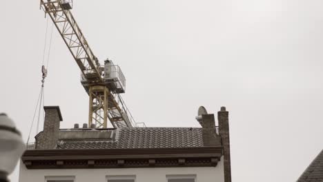 Construction-crane-towering-over-city-rooftops