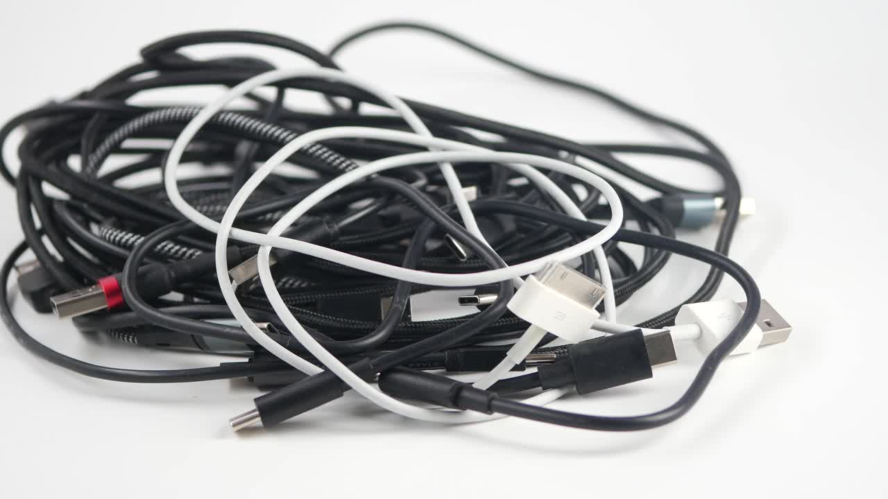 Pile of Tangled Black and White Charging Cables