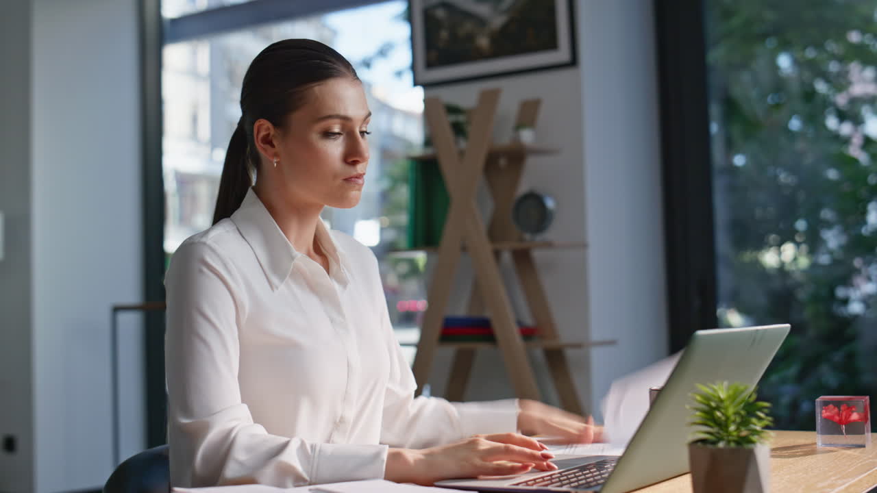 Stressed manager checking report looking laptop screen in office space closeup