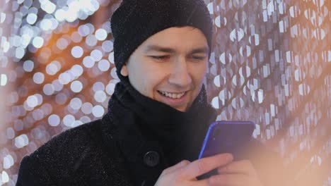 man sms typing on smartphone app, night, christmas