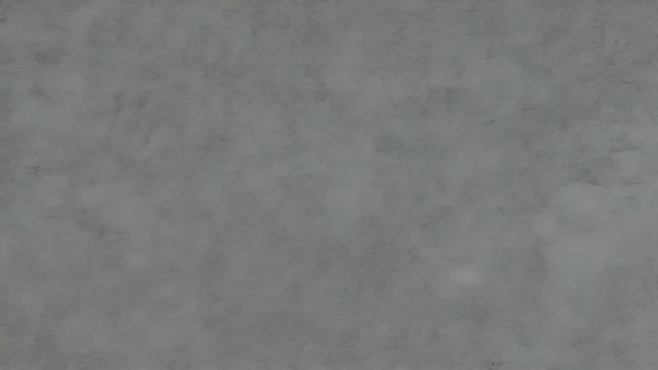 Camera recording gray mottled wall close-up, showing subtle lighting shifts for texture study