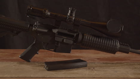 Dolly-out-of-unloaded-AR-15-on-a-wooden-surface