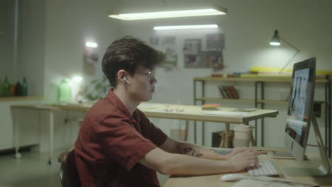 young man working on a computer in an office