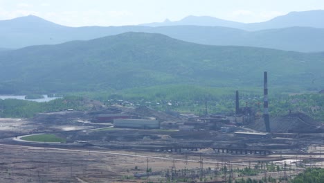 industrial landscape with mining operations and mountains