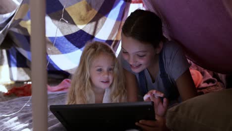 Sisters-under-sheets-forming-a-tent