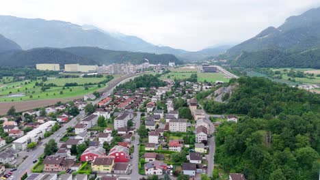 aerial wide shot of domat ems city in switzerland. summer day with houses and homes between alps