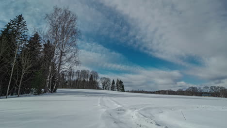 A-sunset-timelapse-of-a-snowy-field-from-midday-to-dusk