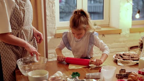 grandmother and granddaughter baking christmas cookies