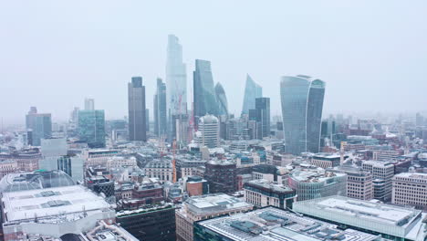 London-snow-aerial-city-centre-skyscrapers-beautiful-rotating-drone-shot