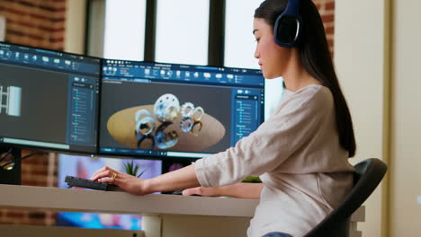 Asian-industrial-designer-puts-headset-on-and-works-with-3D-rendering-software