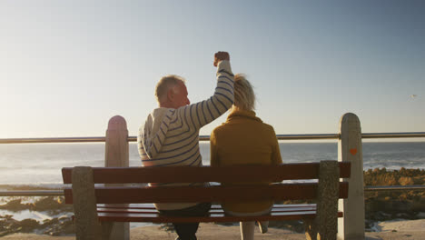 Senior-couple-embracing-each-other-at-beach