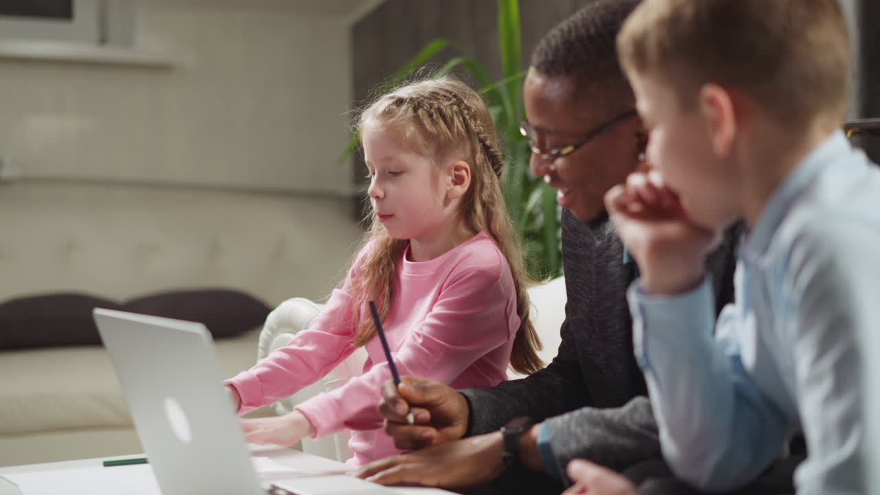 Girl turns paper to write at English lesson with teacher