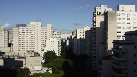 Drone-Aerial-Shoot-of-the-Cityscape-of-a-Big-Metropolis-Passing-Through-Big-Buildings-on-Sao-Paulo-city,-Brazil,-Dolly-In-and-Crane-Up-Camera-Going-Up-Revealing-The-City-on-Higienopolis-District