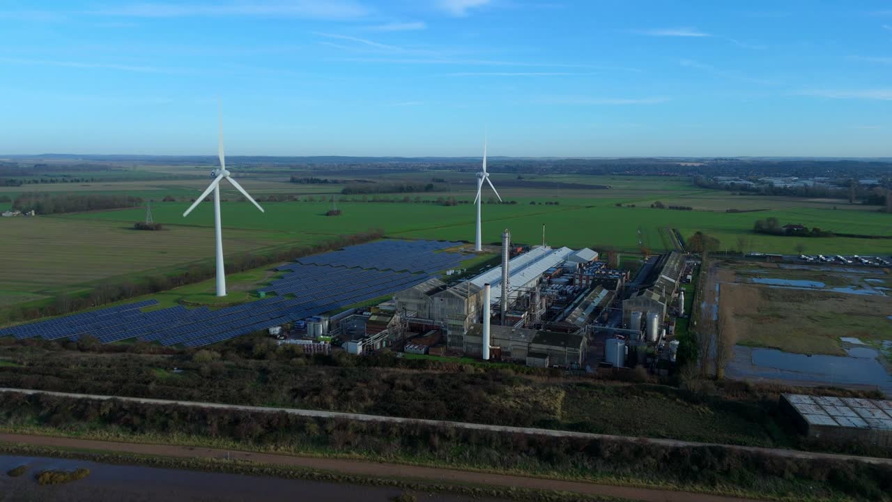 Sustainable manufacturing drone overview of a King's Lynn industrial estate featuring renewable wind and solar power infrastructure