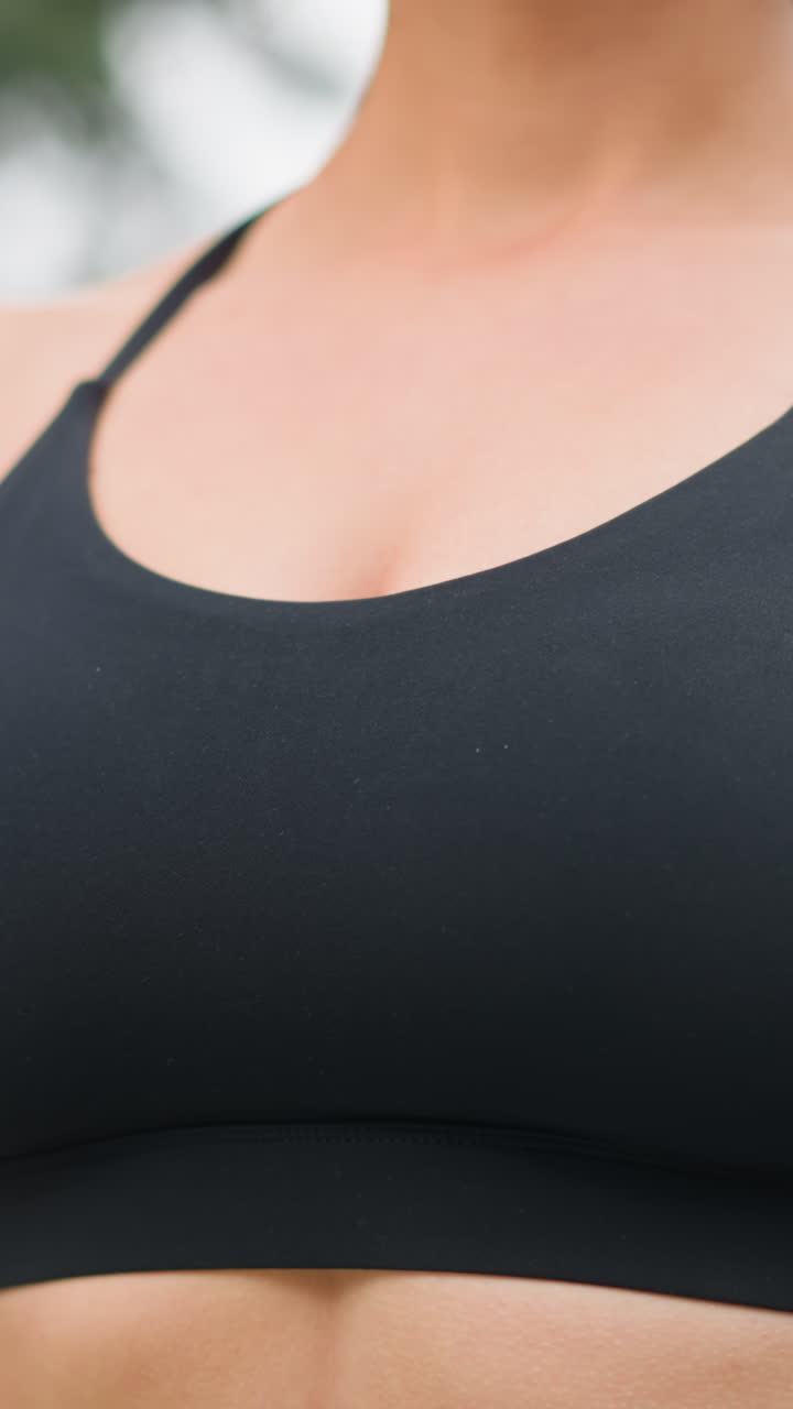 Close-up view of athlete chest area, showing breathing in and out during physical activity, emphasizing fitness and strength, with focus on the top and torso area while wearing sports attire