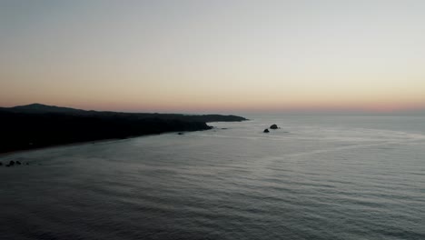 Aerial-shot-of-sunset-at-oaxacan-coast,-Mazunte-Oaxaca,-Mexico