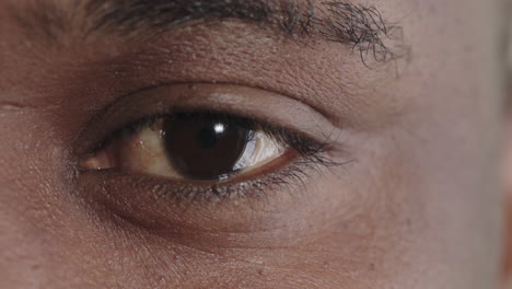 close-up-african-american-man-eye-opening-looking-at-camera-blinking-iris-detail